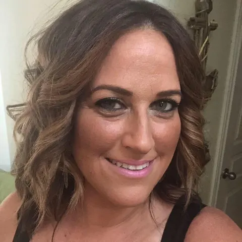 The original selfie: a smiling woman with wavy brown hair